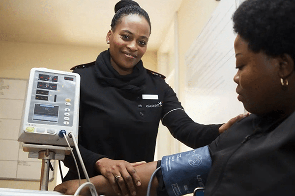 Nurse measures a woman's blood pressure 