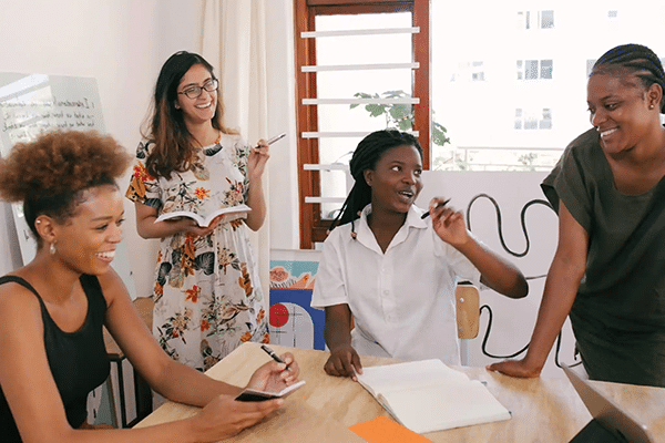 Four women talk around a table