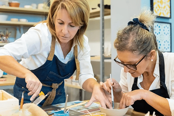 Two women painting